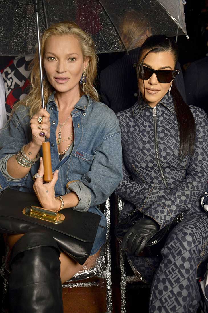 Kate Moss, left, Kourtney Kardashian and Travis Barker attend the